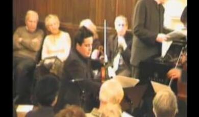 Still of Gresham audience and musicians at the lecture
