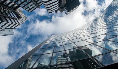 Cityscape reflected in glass facade