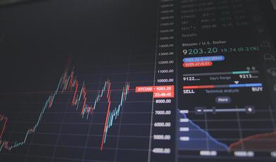 digital screen showing financial data and graphs