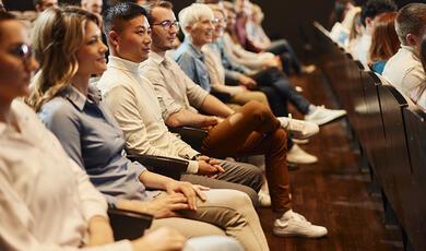 Group of people in audience watching something