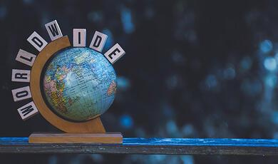 close up of globe with letters spelling world wide above