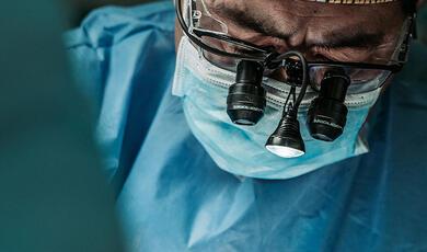 Close up of surgeon wearing loupes during operation