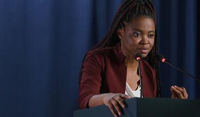 Black female speaker at lecturn