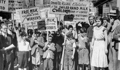 a black and white photograph of a group of people holding placards