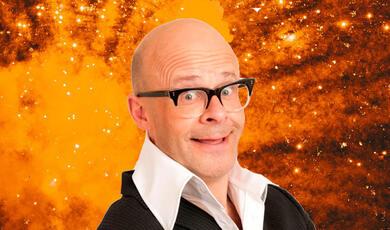 Harry Hill with Big bang in backgroun