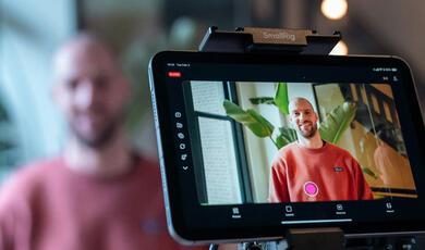 Behind camera shot of young man smiling while being interviewed