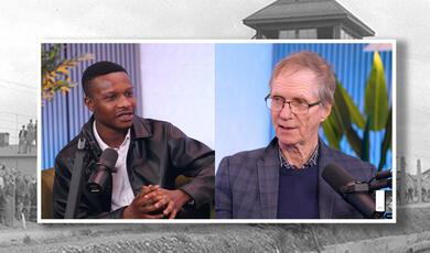 Antony Penrose and Jeoffrey Sarpong on a backdrop of a Miller photograph of a Nazi camp