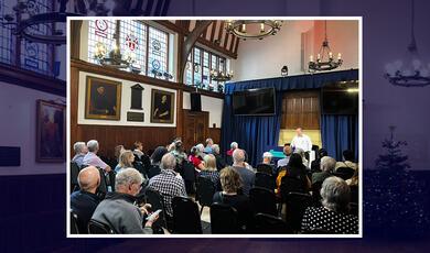 Visitors listening to a lecture on the history of Gresham College and Barnard's Inn