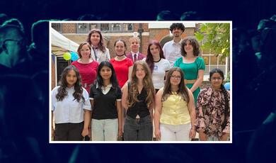 Group photo of the 12 finalists outside in our courtyard