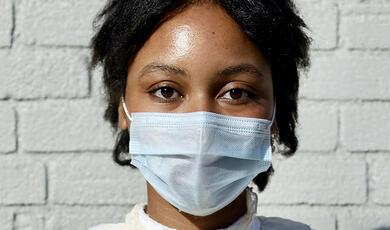 close up of face of black lady wearing mask