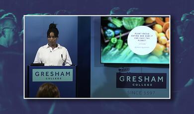 Picture of the winner of the first Gresham College Oracy Competition speaking at podium