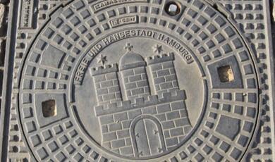 Drain cover in Hamburg showing castle motif