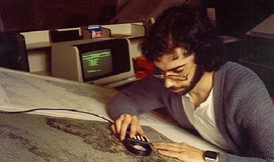 weather analyst bent over map