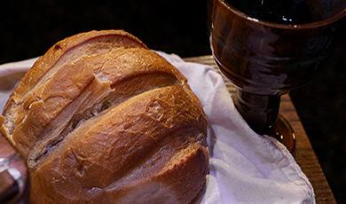 a loaf of bread and a glass of wine