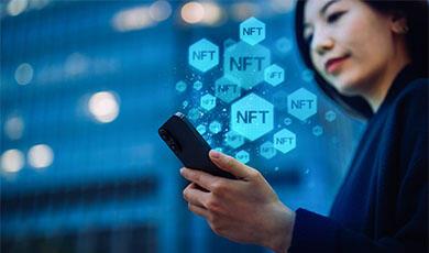 a lady looking at smartphone with NFT graphics rising from it