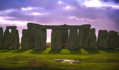 Stonehenge against a purple cloudy sky