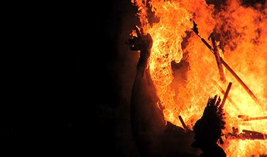 Viking longboat with dragon head on fire