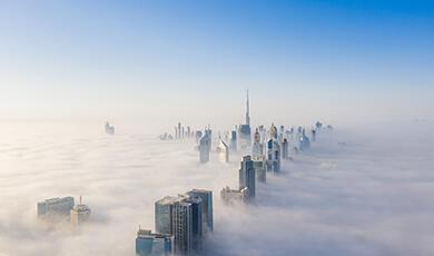 the dubai city skyline covered in low cloud