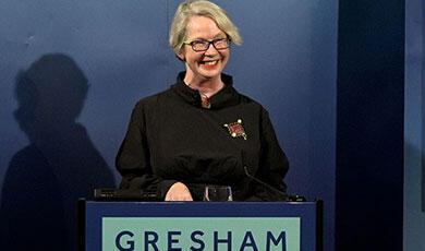 Joanna Bourke standing behind a podium