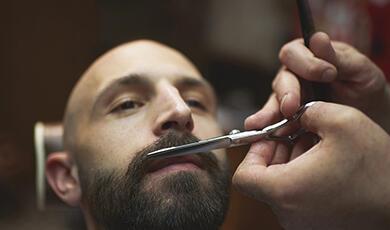 Man having his beard trimmed