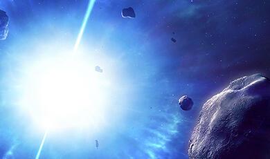 a bright light in space with asteroids in the foreground
