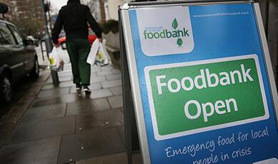 a sign on a street exclaiming that a foodbank is open