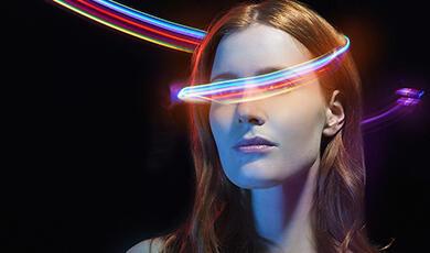a woman with colourful beams swirling around her head