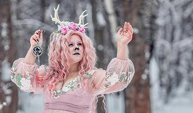 Woman in punk dress, flowers and antlers