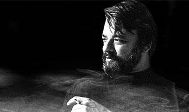 a black and white image of Stephen Sondheim smoking a cigarette