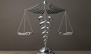 scales of justice with caduceus as middle shaft