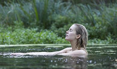 Woman bathing in lake