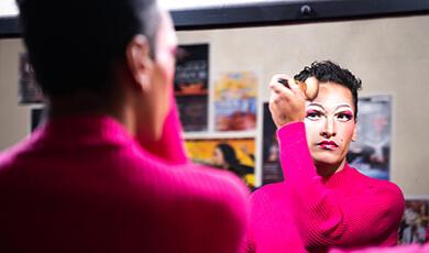 a man applying himself with makeup