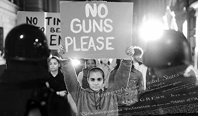 a woman holding a sign saying 'No Guns Please'