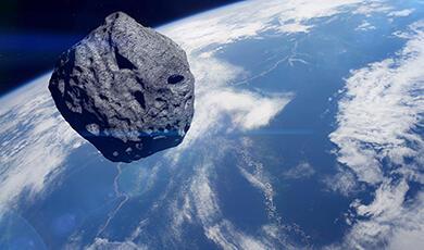a cgi asteroid shown in space with planet earth in the background