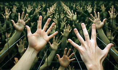 Pair of hands multiplied in hall of mirrors