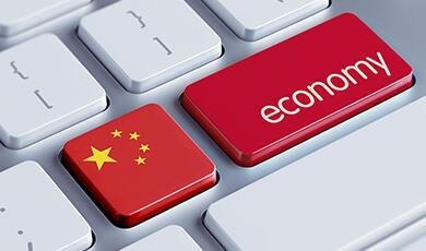 A close-up of a computer keyboard with a red key labeled "economy" and a key with the flag of China