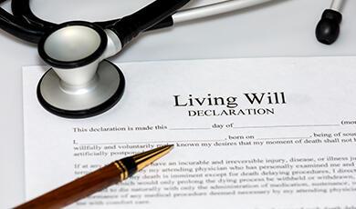 A living will document with a stethoscope and a pen on top