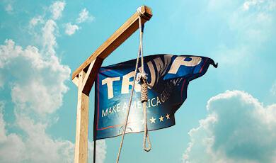 A "TRUMP MAKE AMERICA GREAT AGAIN!" flag hanging from a wooden gallows with a noose