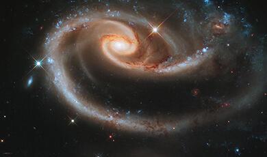 Interacting spiral galaxies Arp 273, with the larger galaxy tidally distorted into a rose-like shape by its companion