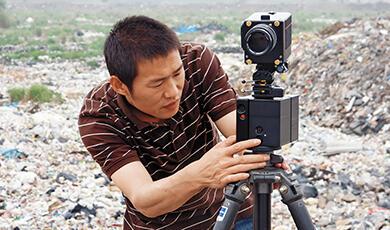 Chinese filmaker setting up video camera