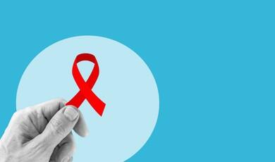 A close-up graphic features a black-and-white hand holding a vibrant red awareness ribbon against a light blue circular backdrop, all set on a solid bright blue background