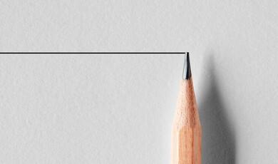 A sharpened wooden pencil tip touching a straight black horizontal line on a textured off-white paper background
