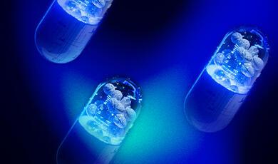 Neon pill capsule with technology sumbols and brains floating inside