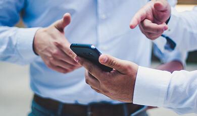 Men pointing to phone