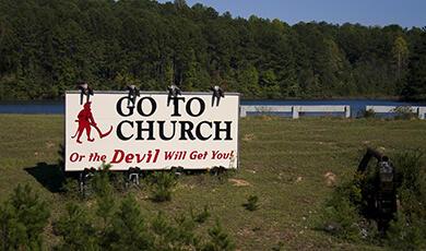Religious billboard in field