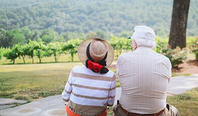 Old people sitting on blanket outside