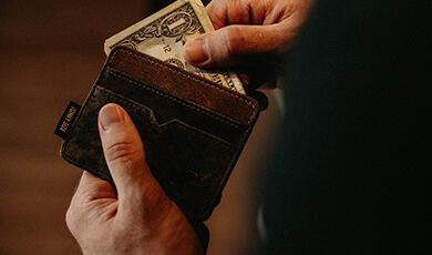 Person taking money out of wallet