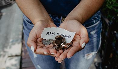 Person holding hands out with coins