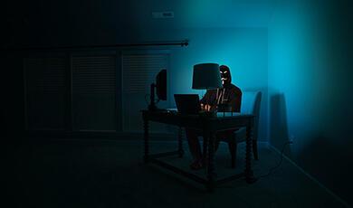 Person on computer in dark room