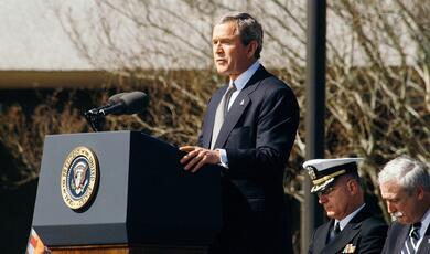 George W Bush speaking at lecturn